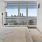 a bedroom with a view of the city