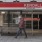 a person walking in front of a store