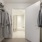 a room with a closet and clothes on the wall