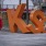 a person walking by a large orange sign