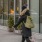 a woman walking in front of a store front